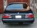 1992 Mercury Grand Marquis - Rear view of a black BMW M6 with custom Dinan badging and a California license plate.