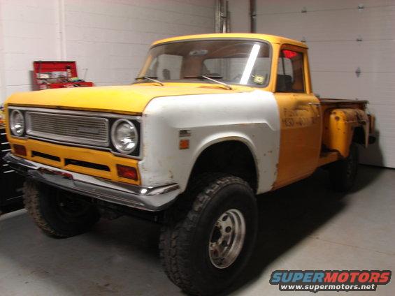 Yellow and white pickup truck with chrome grille and large tires