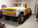 1971 International School Bus - This pickup truck, likely a 1971 model based on its grille, is shown in a garage with a two-tone paint scheme.