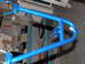 1994 Ford F-150 - A blue metal frame, likely a part for a vehicle, is shown in a workshop setting.