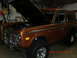 1973 Ford Bronco - A 1973 Ford Bronco is parked indoors with its hood raised, revealing the engine compartment.