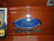 1973 Ford Bronco - Close-up of Ford Bronco emblem on an orange vehicle. Date stamp shows 1/1/2011.
