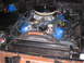1973 Ford Bronco - Close-up view of an engine bay, blue valve covers and a prominent air filter assembly.