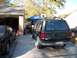 1994 Ford Explorer - Rear view of a dark green 1994 Ford Explorer parked in a driveway next to another car.