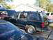 1994 Ford Explorer - Side view of a dark blue 1994 Ford Explorer SUV parked outdoors with its hood open.