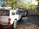 1994 Ford Explorer - Multiple vehicles, including a Jeep Cherokee and a Ford pickup, are parked in a gravel lot.