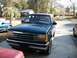 1994 Ford Explorer - A dark green 1994 Ford Explorer is parked in a driveway with other vehicles nearby.