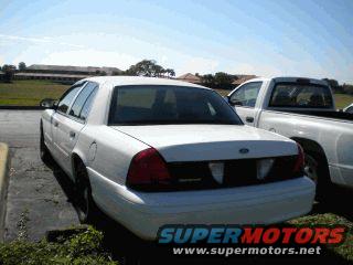White 2002 Ford Crown Victoria, rear 3/4 view, parked in lot