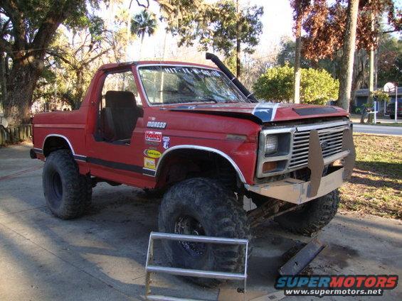 Red 1986 Ford Bronco with custom bumper and snorkel
