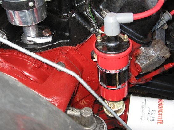 Engine block with red paint, ignition coil, and Motorcraft oil filter
