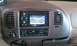 1999 Ford Expedition - The interior of a vehicle features a navigation system and climate control panel.