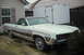 1971 Ford Ranchero - A light green 1970 Ford Ranchero with wood paneling is parked in front of a house and trailer.
