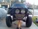 1992 Ford Ranger - Modified 1992 Ford Ranger front end with off-road lights and suspension, supported by a jack.