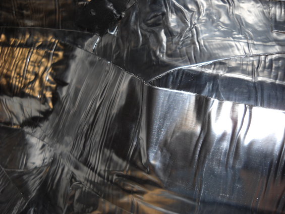 Black vinyl interior upholstery with reflective creases and seams