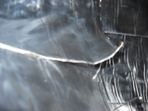 close-up of black plastic sheeting with metallic tape