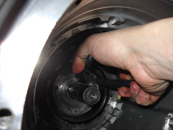 Hand working on internal transmission components, likely during an E4OD rebuild