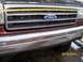 1989 Ford Bronco - A tape measure is placed across the grille of a Ford truck, showing the front end detail.