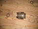 1982 Ford Bronco - A disassembled transmission part, likely a gear or clutch component, is shown with several snap rings on a wooden surface. The image includ…