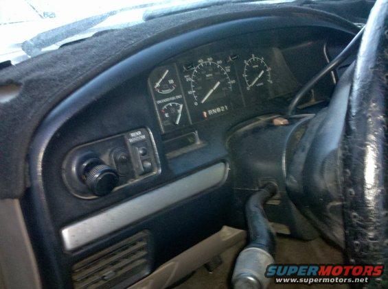 1995 Ford Bronco interior dashboard with speedometer, fuel gauge, and rear window control