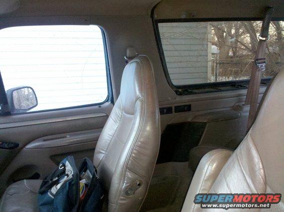 Interior view of a 1995 Ford Bronco showing tan leather seats and door panel