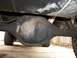 1994 Ford Explorer - Underside view of a vehicle's rear differential, with visible oil buildup and suspension components.