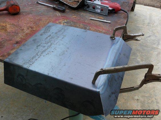metal part clamped on workbench with jigsaw and tools