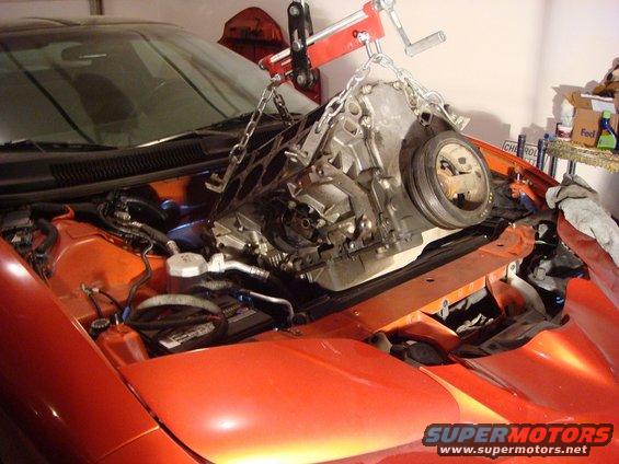 2001 Pontiac Trans Am engine bay with engine being lowered by hoist