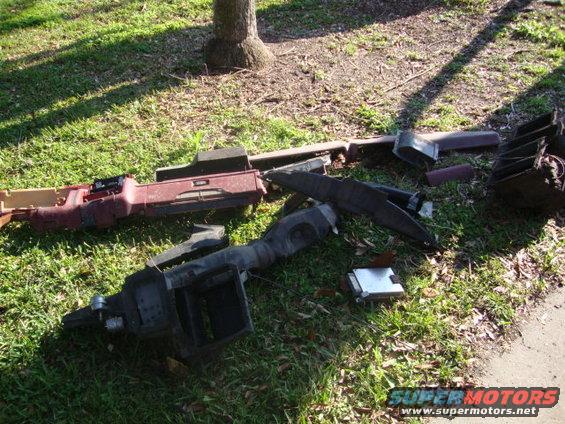 Disassembled dashboard components on grass