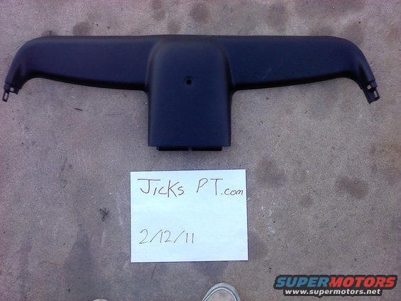 Black plastic automotive interior trim piece with mounting tabs on the sides