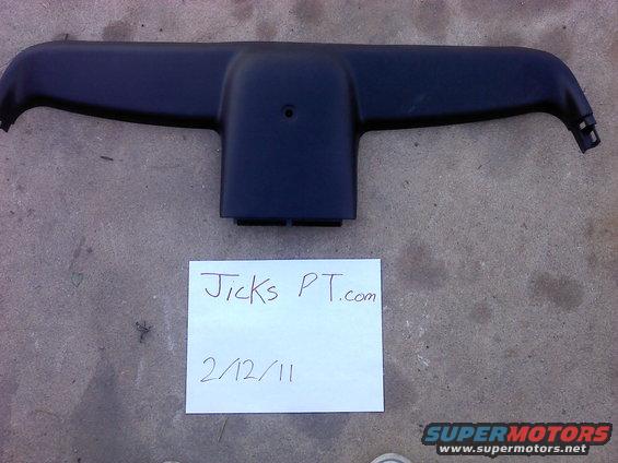 Black plastic interior trim piece with handwritten note 'Jicks PT.com 2/12/11'