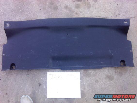 Dark plastic automotive underbody panel with mounting holes