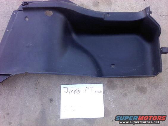 black plastic interior trim piece with a white paper note that says Jicks PT.com