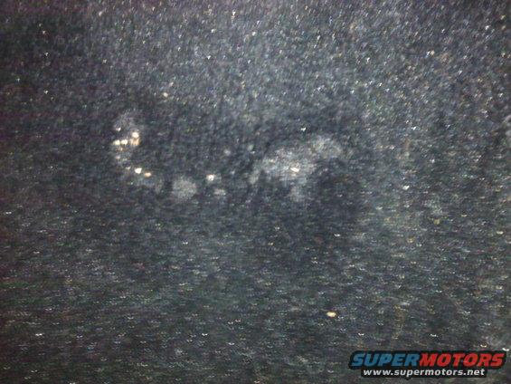Dark textured surface with light spots
