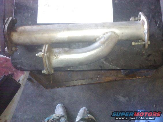Exhaust pipe section with flanges on a workbench