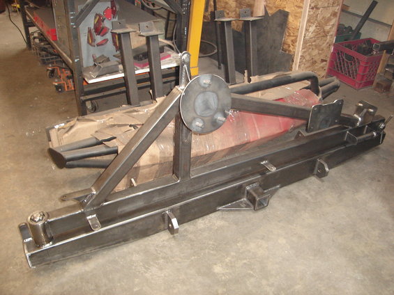 Metal fabrication part with a spare tire mount and tow hitch receiver, viewed from the side