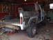 1979 Ford Bronco - This 1978 Ford Bronco is in a garage, seemingly undergoing a significant restoration project with its body panels exposed.