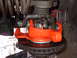 1979 Ford Bronco - Orange painted suspension part installed on a vehicle's brake rotor.