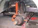 1979 Ford Bronco - Front suspension and brake components, including a shock absorber and rotor, are visible in this close-up.