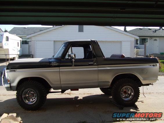 Side view of a two-tone 1979 Ford Bronco with aftermarket wheels