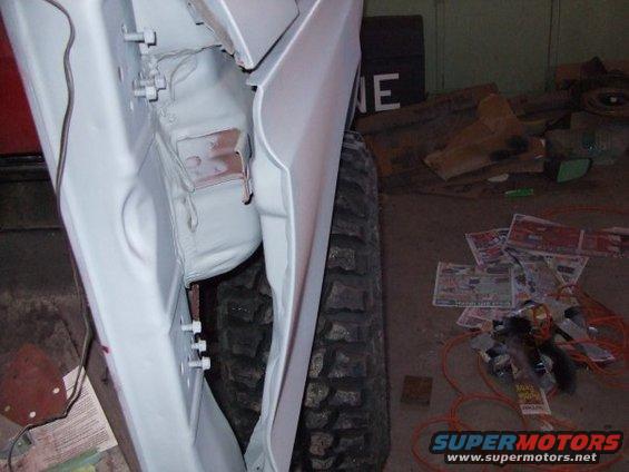 White 1979 Ford Bronco door and tire during restoration