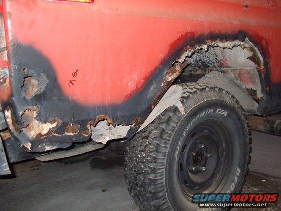 1979 Ford Bronco rear fender with significant rust damage and a '10"' mark