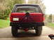1989 Ford Bronco - Rear view of a red 1989 Ford Bronco a custom bumper and spare tire carrier. License plate is visible.