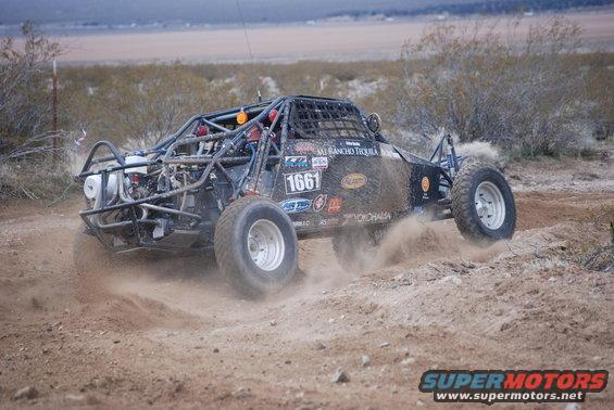 Buggy with number 1661 kicks up dirt on a desert race course