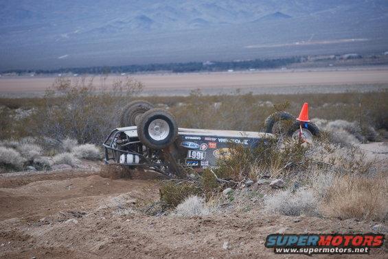Off-road buggy on its side with number 1991 visible