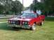 1972 Ford Ranchero - This red 1977 Ford Ranchero features a distinctive front end with quad headlights and a prominent grille.