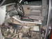 1992 Ford Ranger - The interior of a truck shows exposed wiring and a stripped floor, indicating it is undergoing modification or repair.