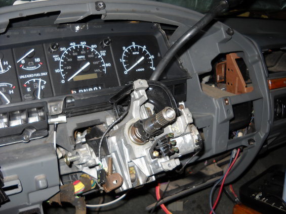 Disassembled steering column assembly in a 1992 Ford F-Series truck interior