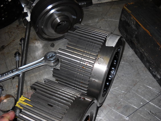 Transmission planetary gear set and clutch drum with a wrench on a workbench