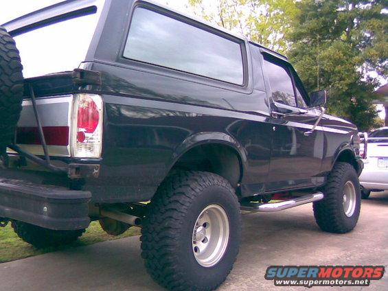 Black 1991 Ford Bronco parked outside, showing its side and rear
