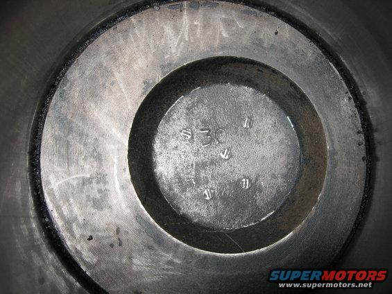 Close-up of an engine cylinder bore with a stamped '30' and other markings